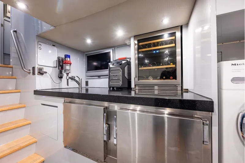 First Home Yacht Photos Pics Modern kitchen area in 1988 Cheoy Lee 92 yacht with wine cooler and stainless steel appliances.