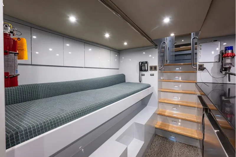 First Home Yacht Photos Pics Luxurious interior of 1988 Cheoy Lee 92 yacht with modern seating and staircase.