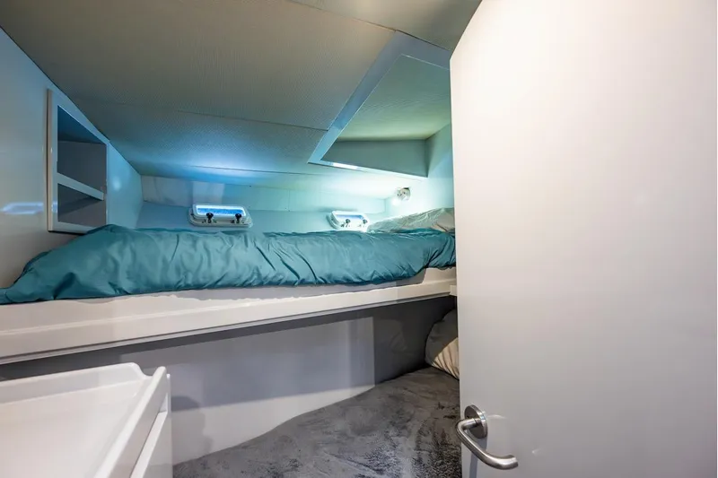 First Home Yacht Photos Pics Cozy cabin interior of 1988 Cheoy Lee 92 yacht with bunk bed and storage.