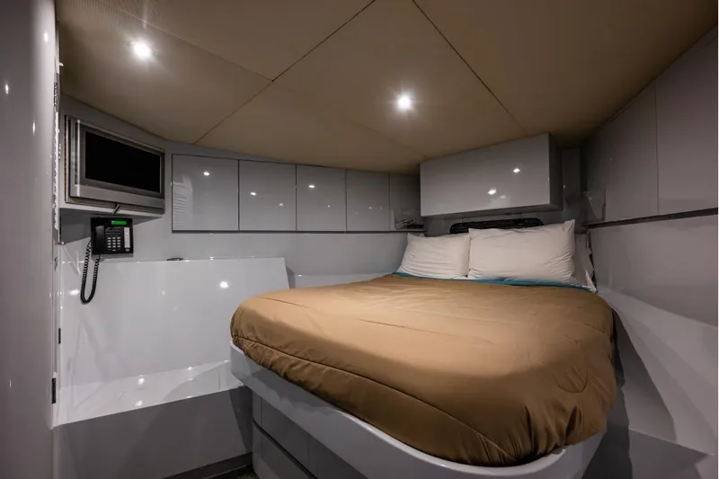 First Home Yacht Photos Pics Luxurious cabin interior of 1988 Cheoy Lee 92 yacht with cozy bed and modern amenities.