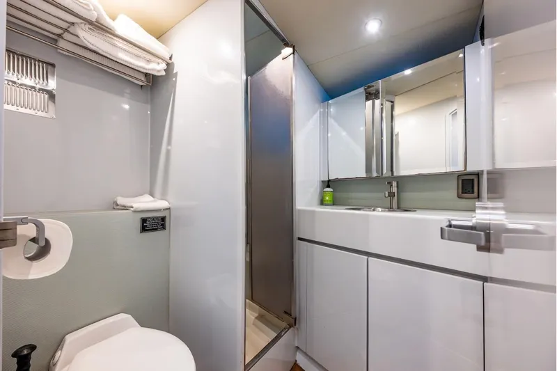 First Home Yacht Photos Pics Luxurious bathroom in 1988 Cheoy Lee 92 yacht with modern fixtures and ample storage.