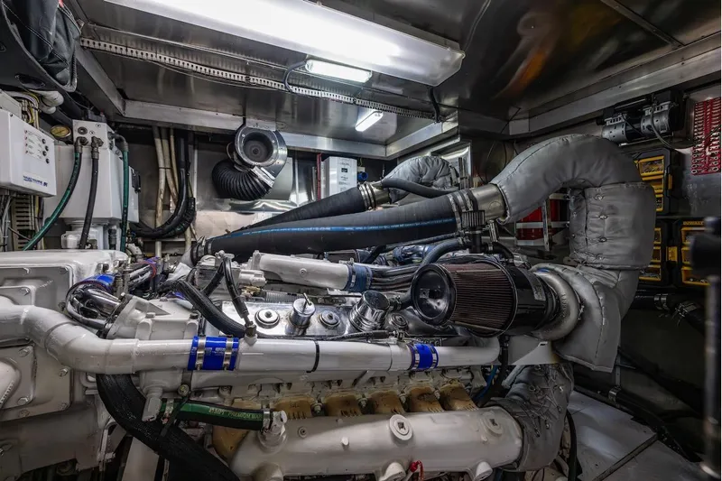 First Home Yacht Photos Pics Engine room of 1988 Cheoy Lee 92 yacht, showcasing complex machinery and piping.