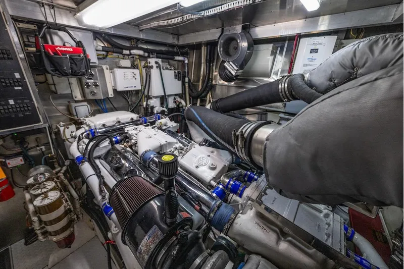 First Home Yacht Photos Pics Engine room of a 1988 Cheoy Lee 92 yacht, showcasing complex machinery and equipment.