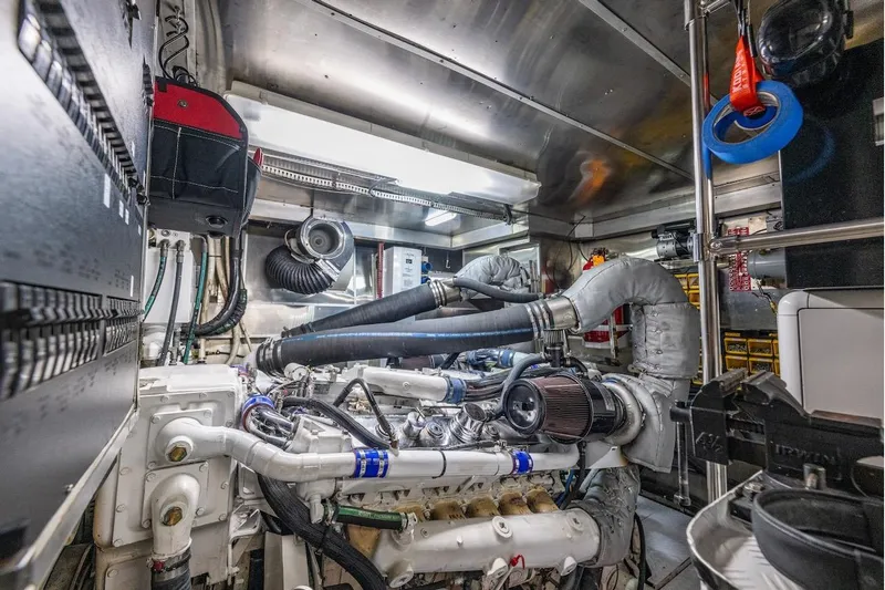 First Home Yacht Photos Pics Engine room of a 1988 Cheoy Lee 92 yacht, showcasing complex machinery and equipment.