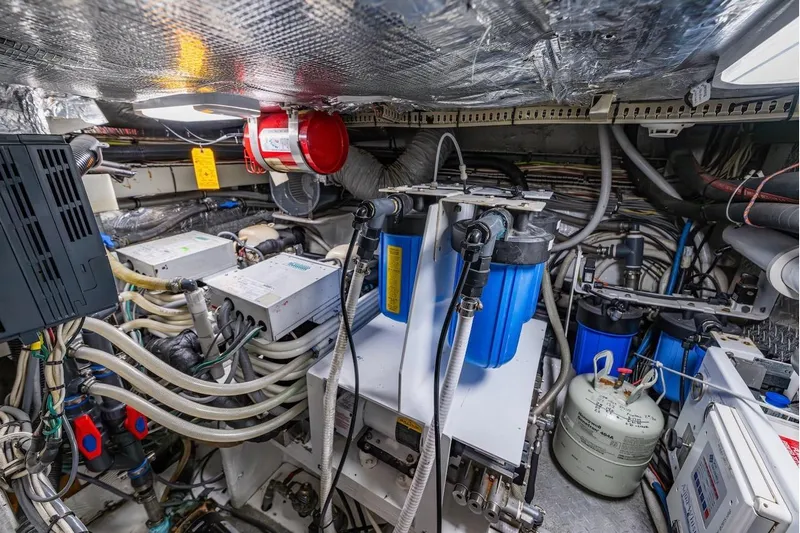 First Home Yacht Photos Pics Engine room of 1988 Cheoy Lee 92 yacht with complex machinery and wiring.