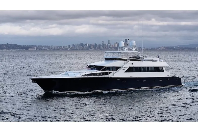 First Home Yacht Photos Pics 1988 Cheoy Lee 92 yacht cruising with city skyline in the background.