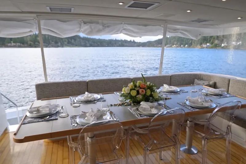 First Home Yacht Photos Pics Luxurious dining area on 1988 Cheoy Lee 92 yacht with scenic water view.