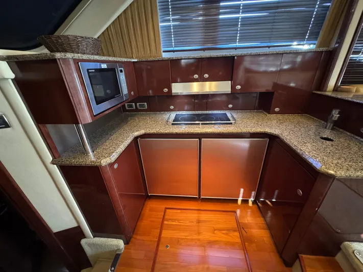 Last Mango Yacht Photos Pics Luxurious kitchen interior of 2007 Sea Ray 52 Sedan Bridge yacht with granite countertops.
