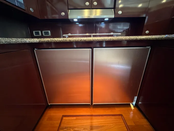Last Mango Yacht Photos Pics Luxurious kitchen area in 2007 Sea Ray 52 Sedan Bridge yacht with wood cabinetry.