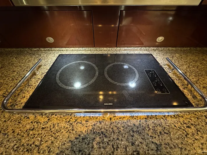 Last Mango Yacht Photos Pics Granite countertop with a sleek electric cooktop on a 2007 Sea Ray 52 Sedan Bridge.