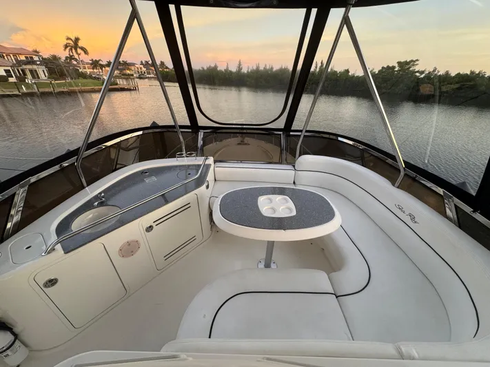 Last Mango Yacht Photos Pics 2007 Sea Ray 52 Sedan Bridge interior with seating and table, overlooking serene waterfront.