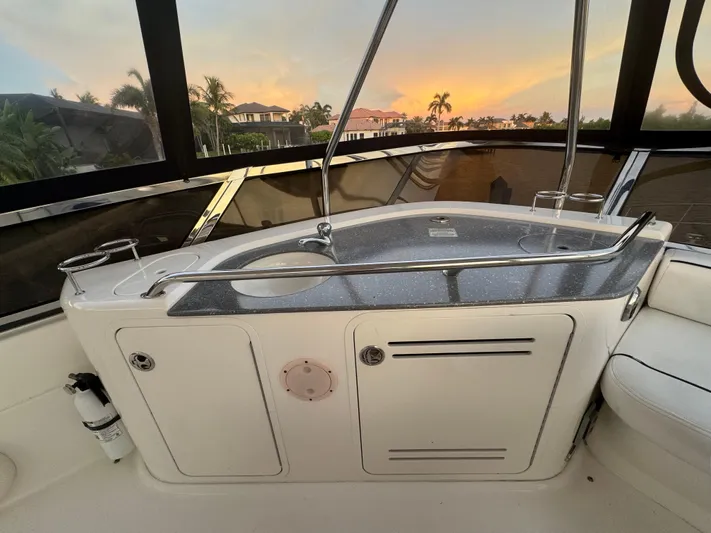 Last Mango Yacht Photos Pics 2007 Sea Ray 52 Sedan Bridge yacht interior with sleek countertop and sunset view.