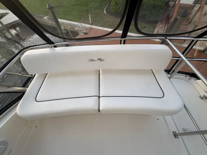 Last Mango Yacht Photos Pics White seating on 2007 Sea Ray 52 Sedan Bridge yacht, featuring sleek design and waterfront view.