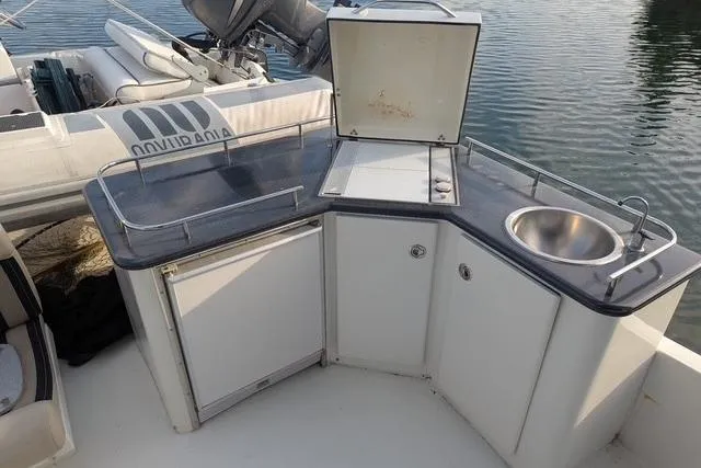 Impulse Yacht Photos Pics Outdoor kitchenette on 2004 Navigator 57 yacht with sink and storage.
