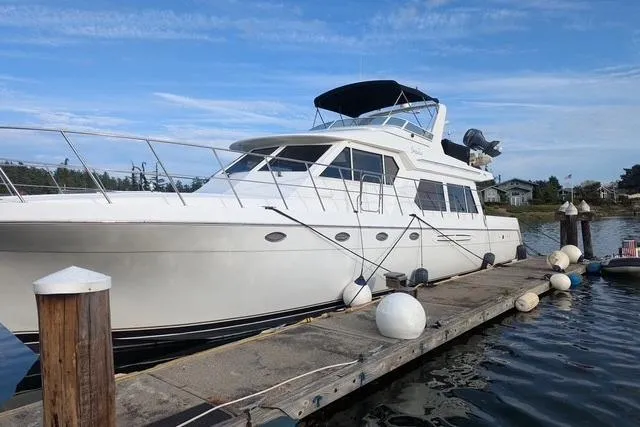 Impulse Yacht Photos Pics 2004 Navigator 57 yacht docked at marina under clear blue sky.