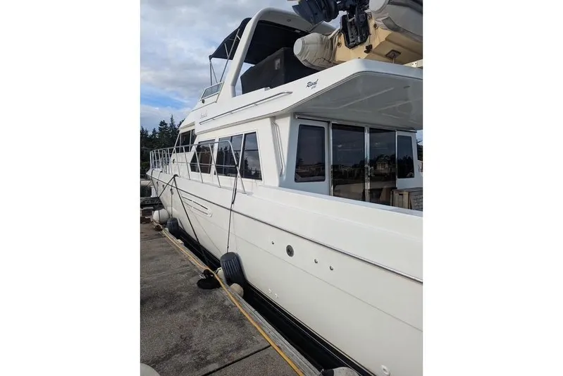 Impulse Yacht Photos Pics 2004 Navigator 57 yacht docked, showcasing sleek design and spacious upper deck.