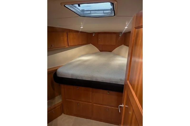 Impulse Yacht Photos Pics Luxurious 2004 Navigator 57 yacht cabin with wood paneling and skylight.