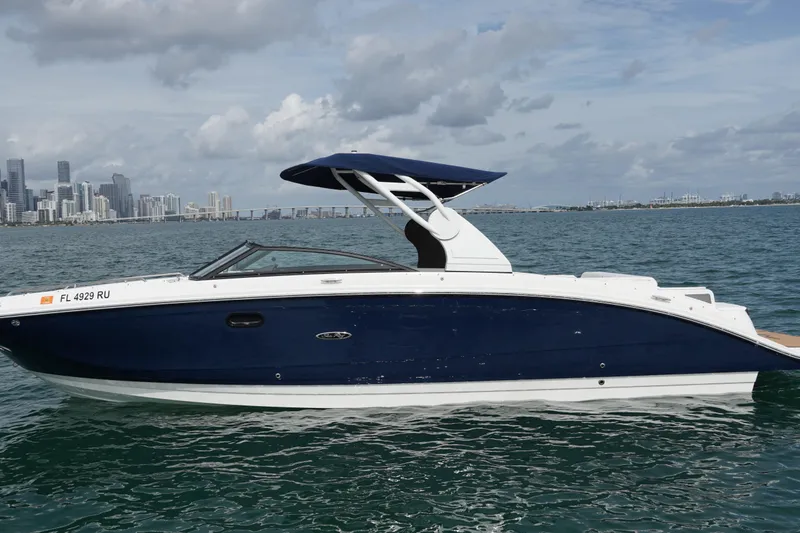  Yacht Photos Pics 2018 Sea Ray SDX 290 boat on water with city skyline in background.