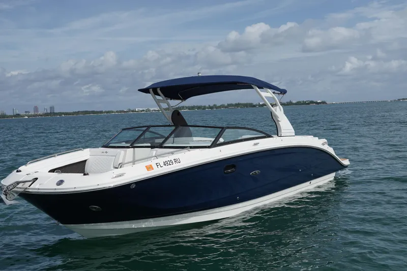  Yacht Photos Pics 2018 Sea Ray SDX 290 boat on calm water under a partly cloudy sky.