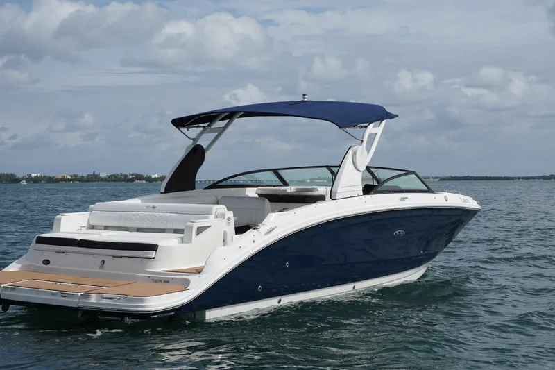  Yacht Photos Pics 2018 Sea Ray SDX 290 boat on calm water with blue canopy.