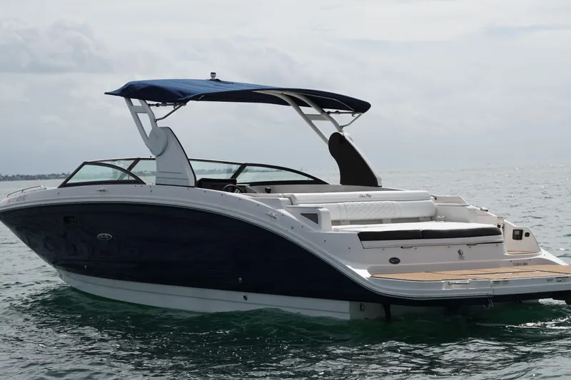  Yacht Photos Pics 2018 Sea Ray SDX 290 boat with blue hull and canopy on open water.
