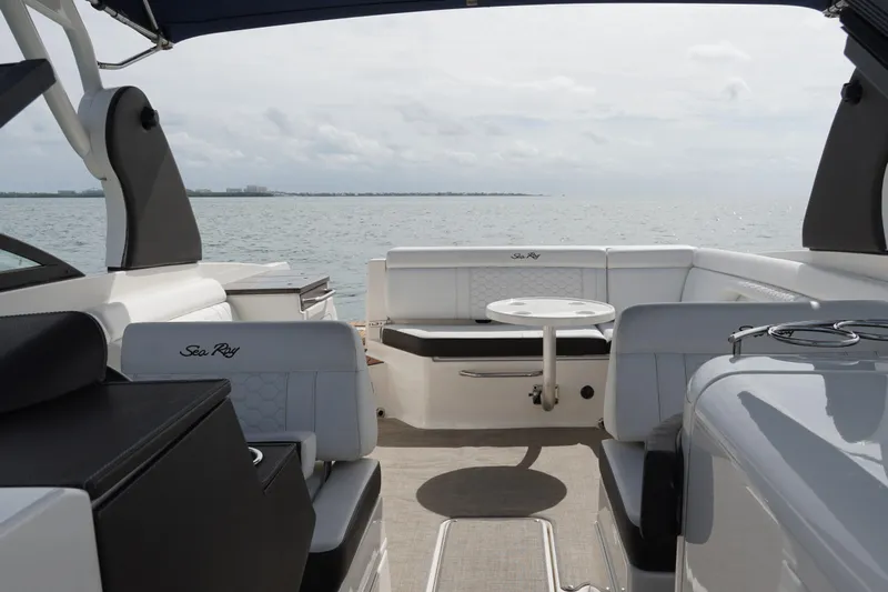  Yacht Photos Pics 2018 Sea Ray SDX 290 boat interior with seating and table, overlooking calm waters.