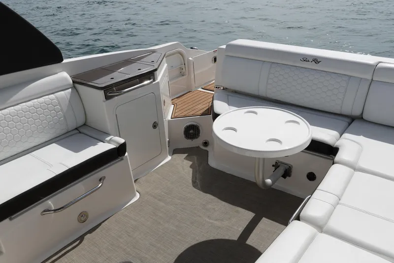  Yacht Photos Pics 2018 Sea Ray SDX 290 boat interior with white seating and table on the water.