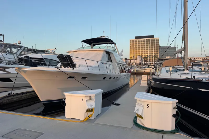 Alexandra Yacht Photos Pics 1998 Bayliner 4788 Pilot House Motoryacht docked at marina during sunset.