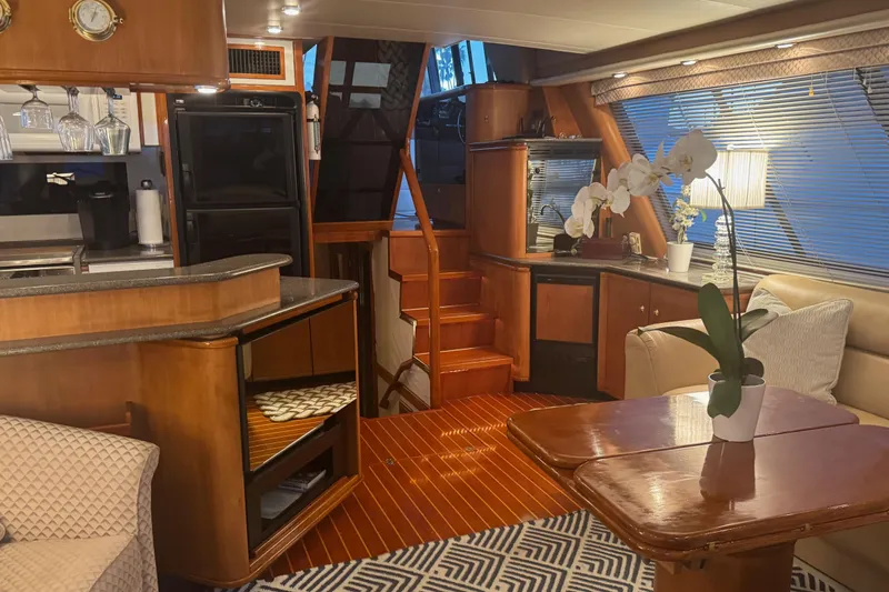 Alexandra Yacht Photos Pics Luxurious interior of 1998 Bayliner 4788 Pilot House Motoryacht with elegant wood finishes.