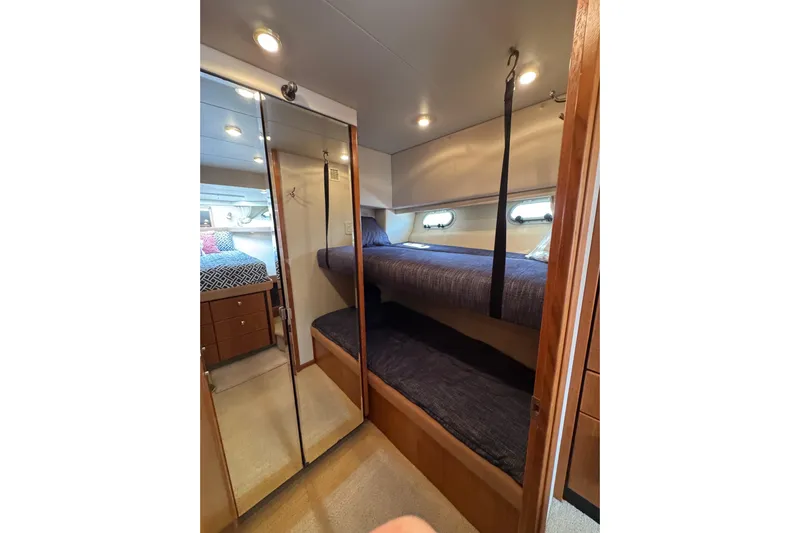 Alexandra Yacht Photos Pics 1998 Bayliner 4788 Pilot House Motoryacht interior with bunk beds and mirrored closet.