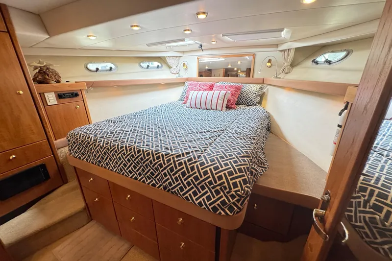 Alexandra Yacht Photos Pics Luxurious bedroom interior of 1998 Bayliner 4788 Pilot House Motoryacht with patterned bedding.