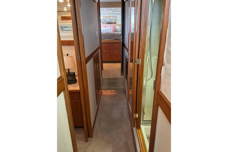 Alexandra Yacht Photos Pics Interior hallway of 1998 Bayliner 4788 Pilot House Motoryacht, featuring wood accents and cozy design.