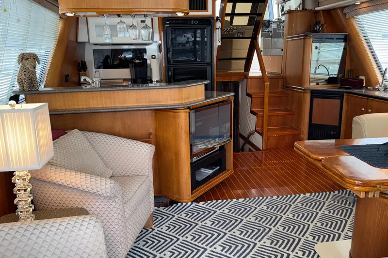 Alexandra Yacht Photos Pics Luxurious interior of 1998 Bayliner 4788 Pilot House Motoryacht with elegant wood finishes.