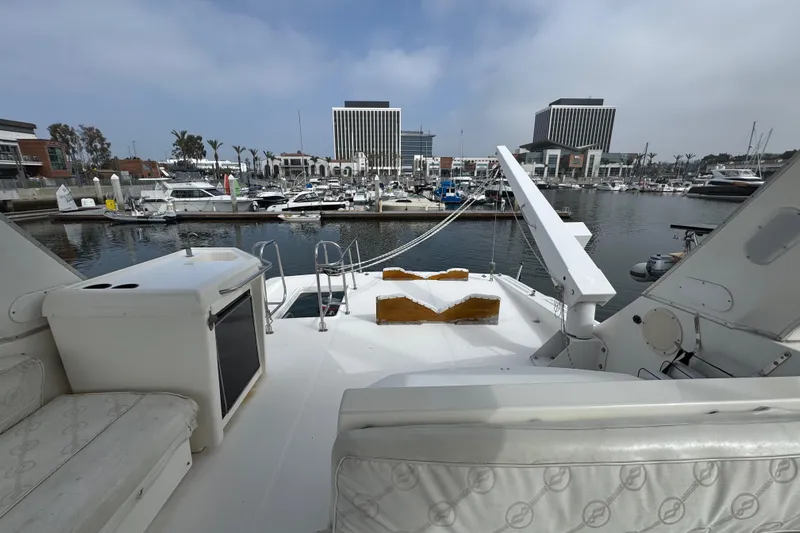 Alexandra Yacht Photos Pics 1998 Bayliner 4788 Pilot House Motoryacht docked in a marina with cityscape background.