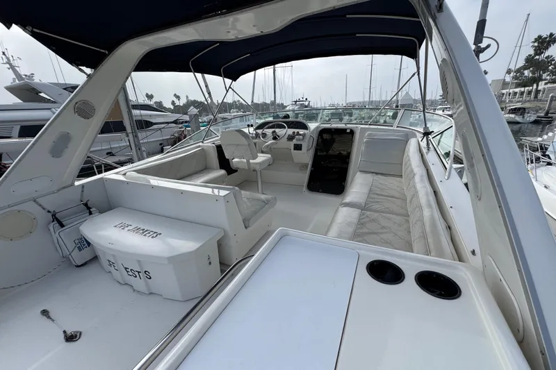 Alexandra Yacht Photos Pics 1998 Bayliner 4788 Pilot House Motoryacht interior with seating and helm, docked at marina.