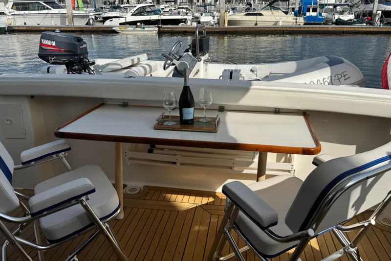 Alexandra Yacht Photos Pics 1998 Bayliner 4788 Pilot House Motoryacht deck with table, chairs, and wine setup.