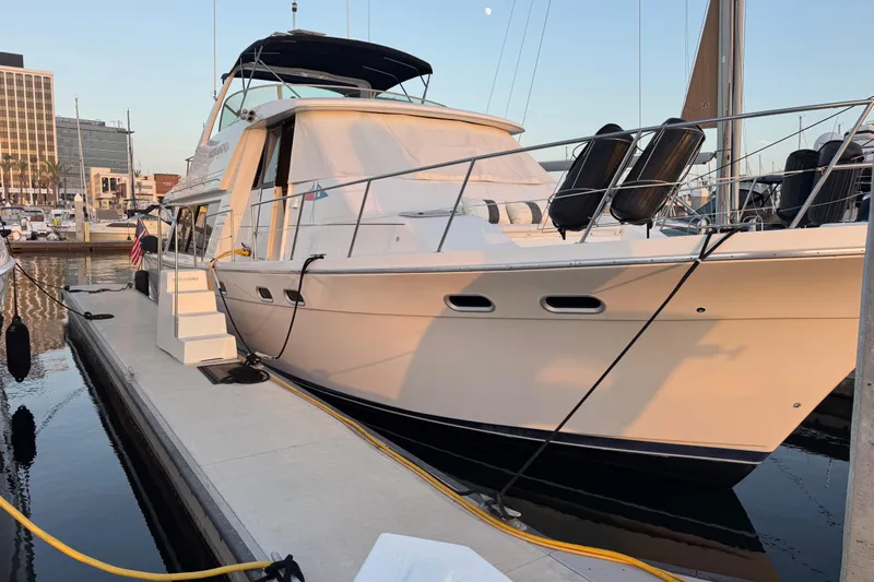 Alexandra Yacht Photos Pics 1998 Bayliner 4788 Pilot House Motoryacht docked at marina during sunset.