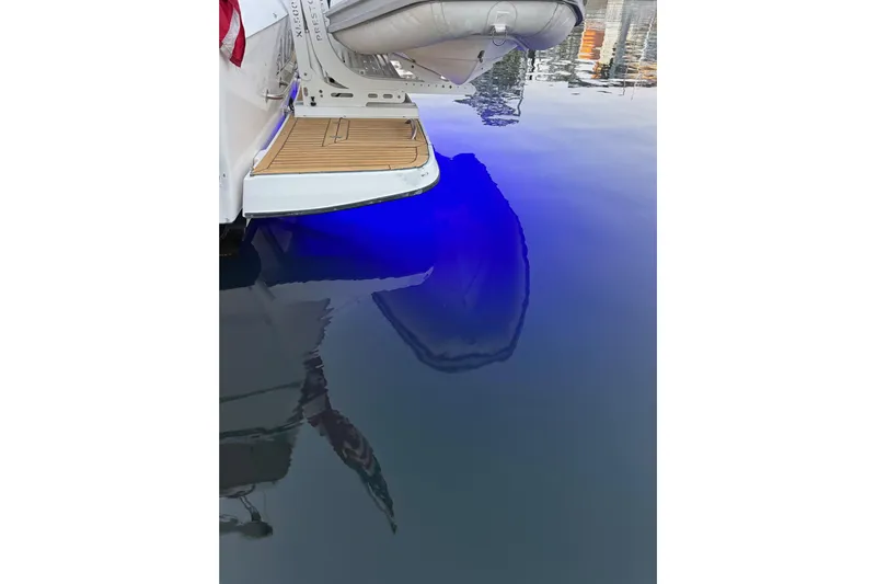 Alexandra Yacht Photos Pics 1998 Bayliner 4788 Pilot House Motoryacht with blue underwater lights at dock.