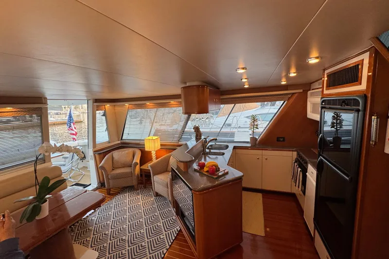 Alexandra Yacht Photos Pics Luxurious interior of 1998 Bayliner 4788 Pilot House Motoryacht with modern kitchen and seating area.