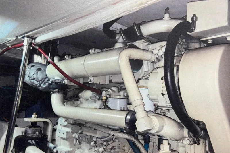 Alexandra Yacht Photos Pics Engine room of 1998 Bayliner 4788 Pilot House Motoryacht, showcasing complex piping and machinery.