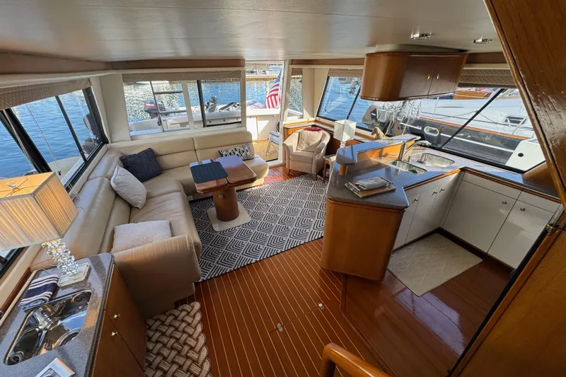 Alexandra Yacht Photos Pics Luxurious interior of 1998 Bayliner 4788 Pilot House Motoryacht with elegant seating and kitchen area.