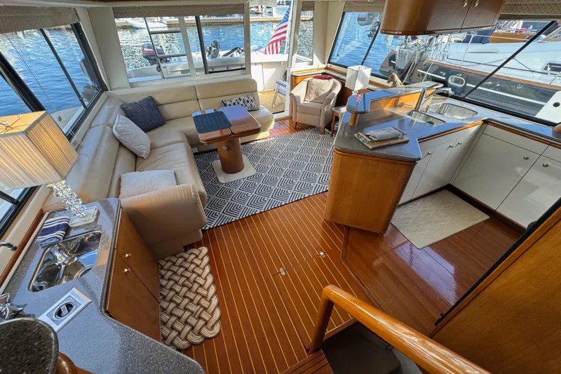 Alexandra Yacht Photos Pics Luxurious interior of 1998 Bayliner 4788 Pilot House Motoryacht with elegant seating and kitchen area.