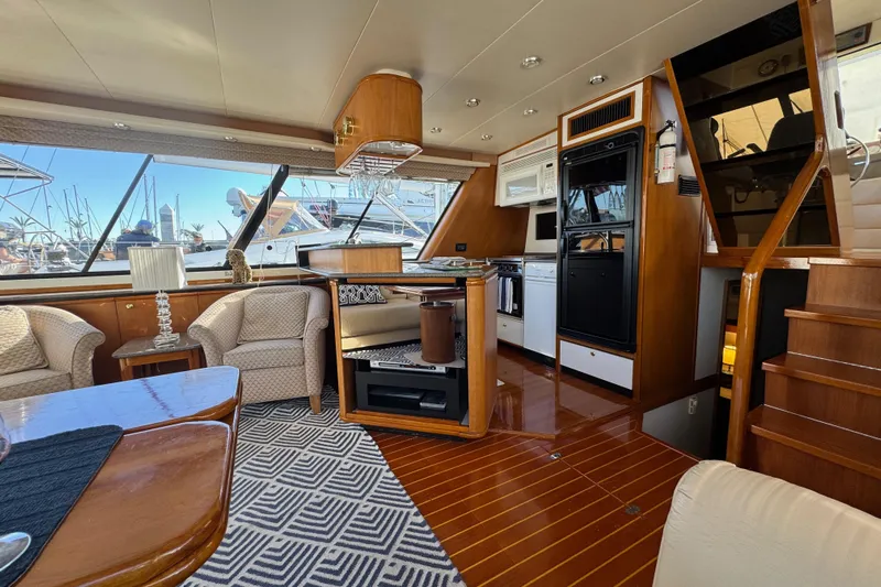 Alexandra Yacht Photos Pics Luxurious interior of 1998 Bayliner 4788 Pilot House Motoryacht with elegant furnishings and modern kitchen.