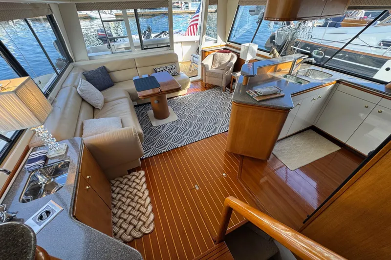 Alexandra Yacht Photos Pics Luxurious interior of 1998 Bayliner 4788 Pilot House Motoryacht with elegant seating and kitchen area.