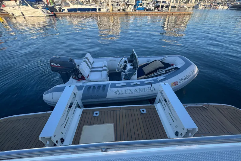 Alexandra Yacht Photos Pics 1998 Bayliner 4788 Pilot House Motoryacht with dinghy and Yamaha motor at marina.