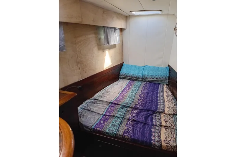  Yacht Photos Pics Cozy cabin interior of 1995 Fountaine Pajot Marquises 56 with colorful bedding.