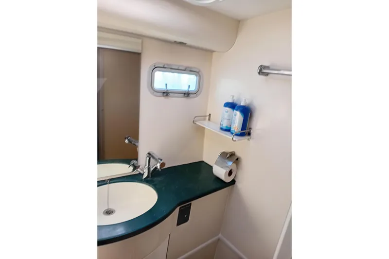  Yacht Photos Pics Bathroom interior of 1995 Fountaine Pajot Marquises 56 catamaran with dual sinks and toiletries.