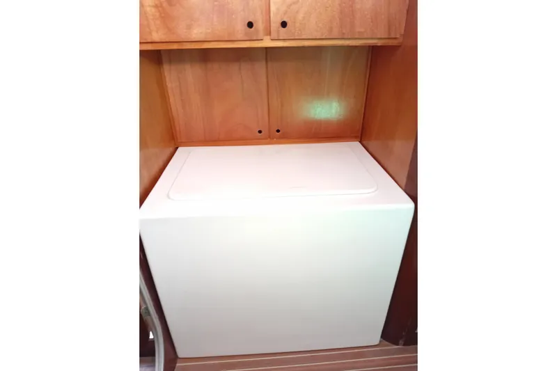  Yacht Photos Pics Laundry area on 1995 Fountaine Pajot Marquises 56 yacht with wooden cabinetry.