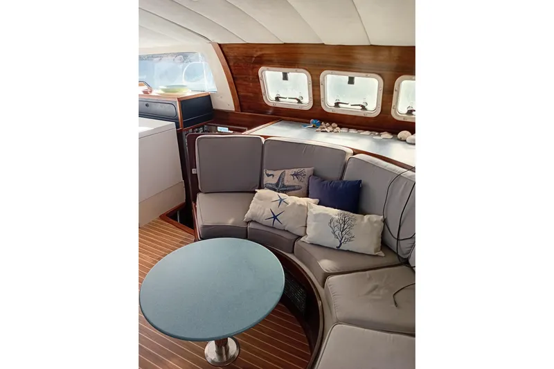  Yacht Photos Pics Interior of 1995 Fountaine Pajot Marquises 56 yacht with cozy seating and nautical decor.