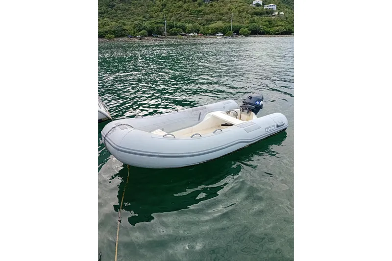 Yacht Photos Pics Inflatable dinghy on water, associated with 1995 Fountaine Pajot Marquises 56 yacht.